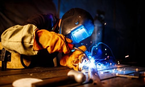 Worker cutting metal with plasma equipment. on plant